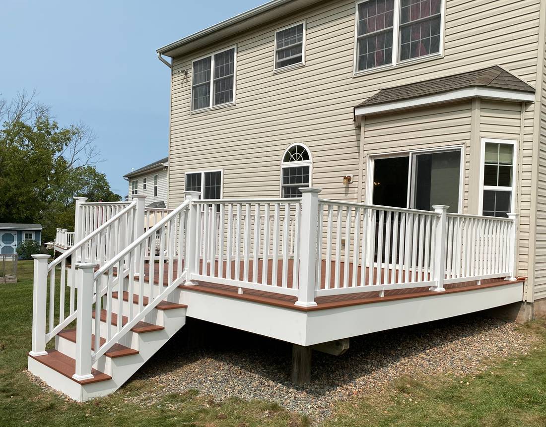 New composite deck with white vinyl railing and black balusters