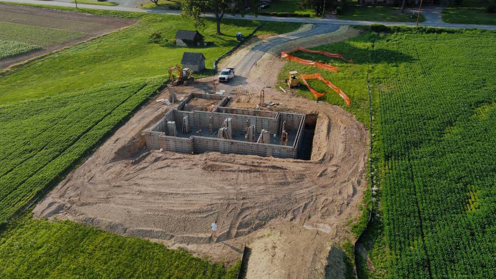 Aerial view of a new foundation being excavated on open land