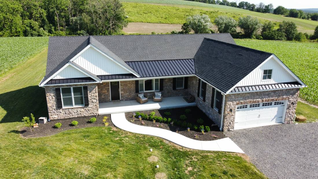 Newly built home with stone and siding exterior and a covered front porch