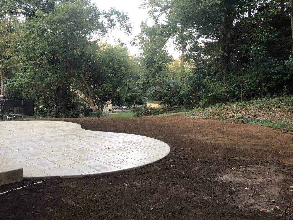 New stamped concrete patio set into a regraded back yard